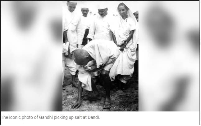 Gandhi picking salt in during Satyagraha photo